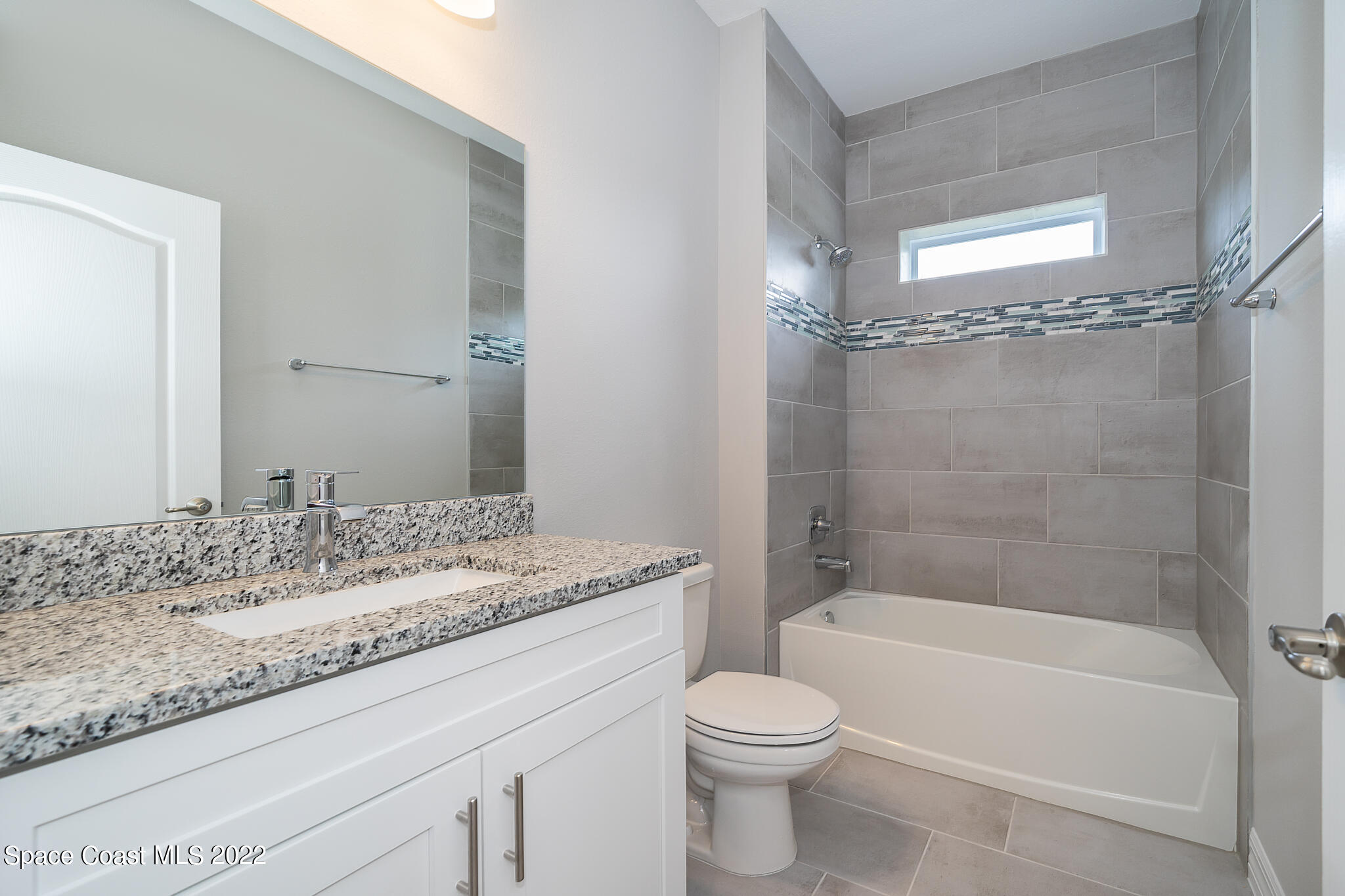 214 Gordon Road Northwest Palm Bay, FL 32907 - Photo 17 of 19 a bathroom with a granite countertop sink toilet and shower