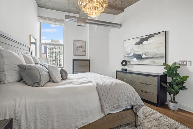 a bedroom with a bed and a potted plant