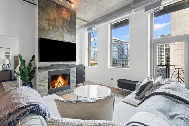 a living room with furniture flat screen tv and a fireplace