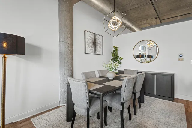 a view of a dining room with furniture and a window