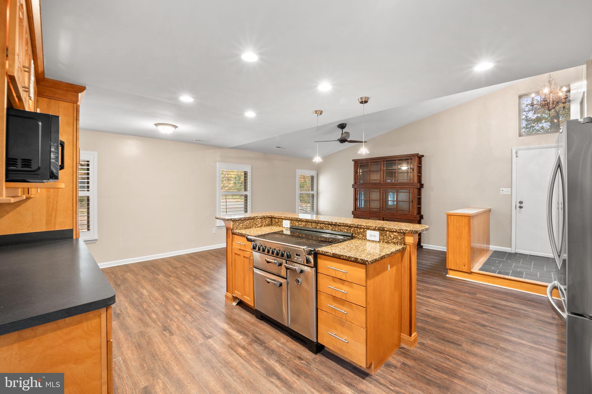 1813 Glade Court Annapolis, MD 21403 - Photo 11 of 35 a kitchen with stainless steel appliances granite countertop a stove and a refrigerator