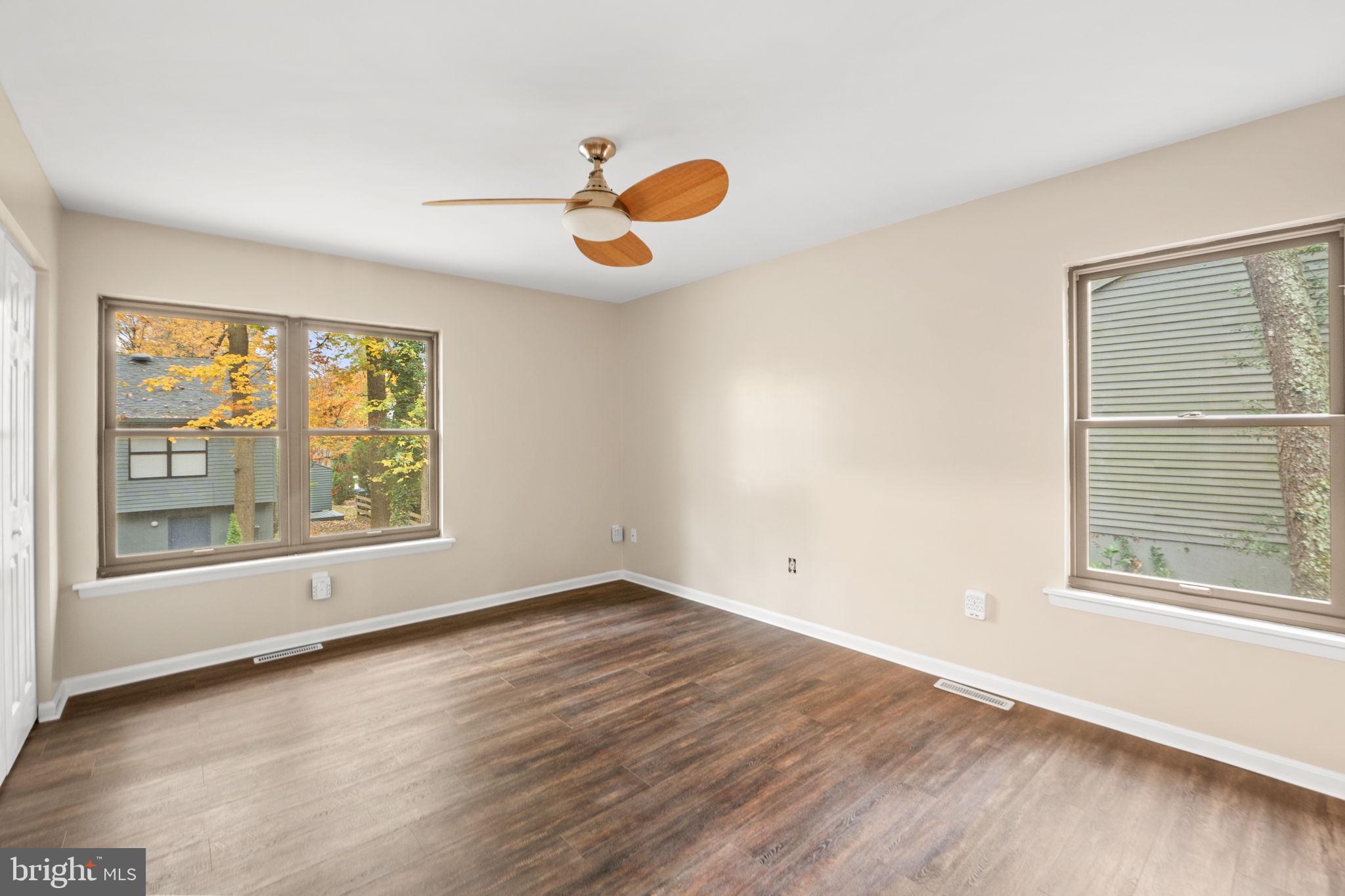 1813 Glade Court Annapolis, MD 21403 - Photo 16 of 35 an empty room with wooden floor and windows