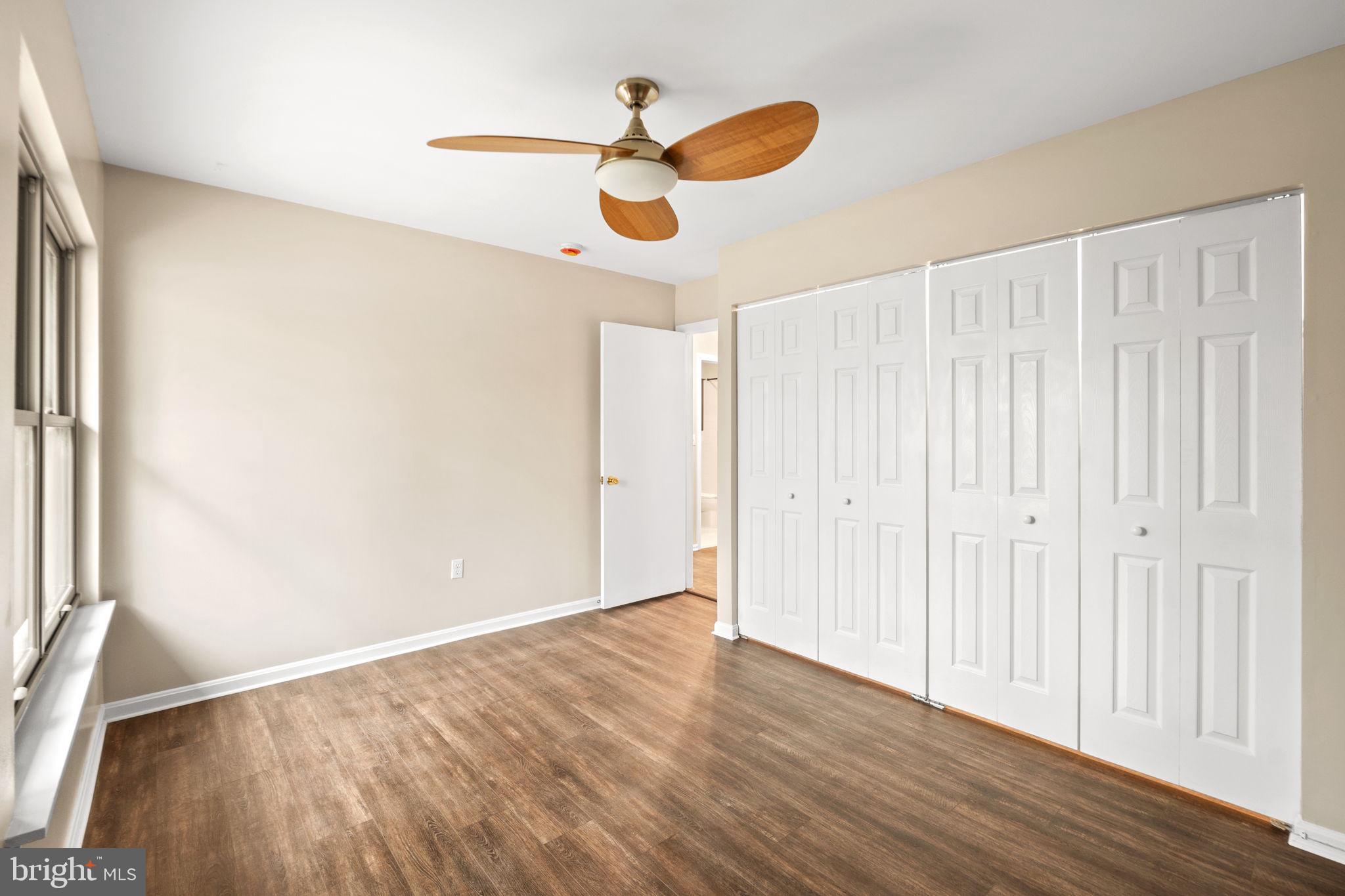 1813 Glade Court Annapolis, MD 21403 - Photo 22 of 35 a view of an empty room with wooden floor and a window