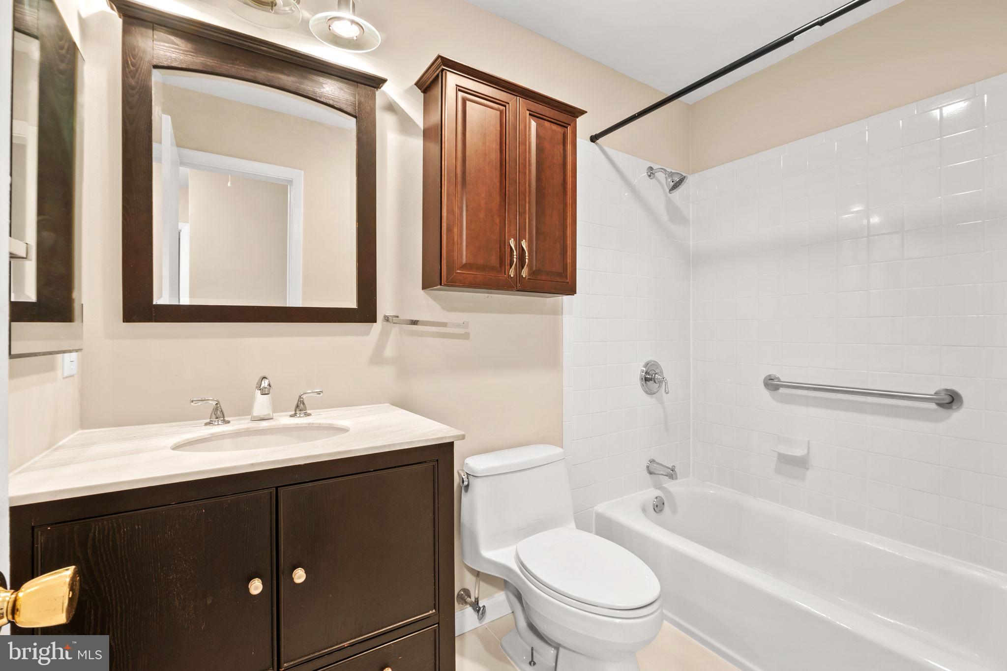 1813 Glade Court Annapolis, MD 21403 - Photo 23 of 35 a bathroom with a sink a toilet and shower