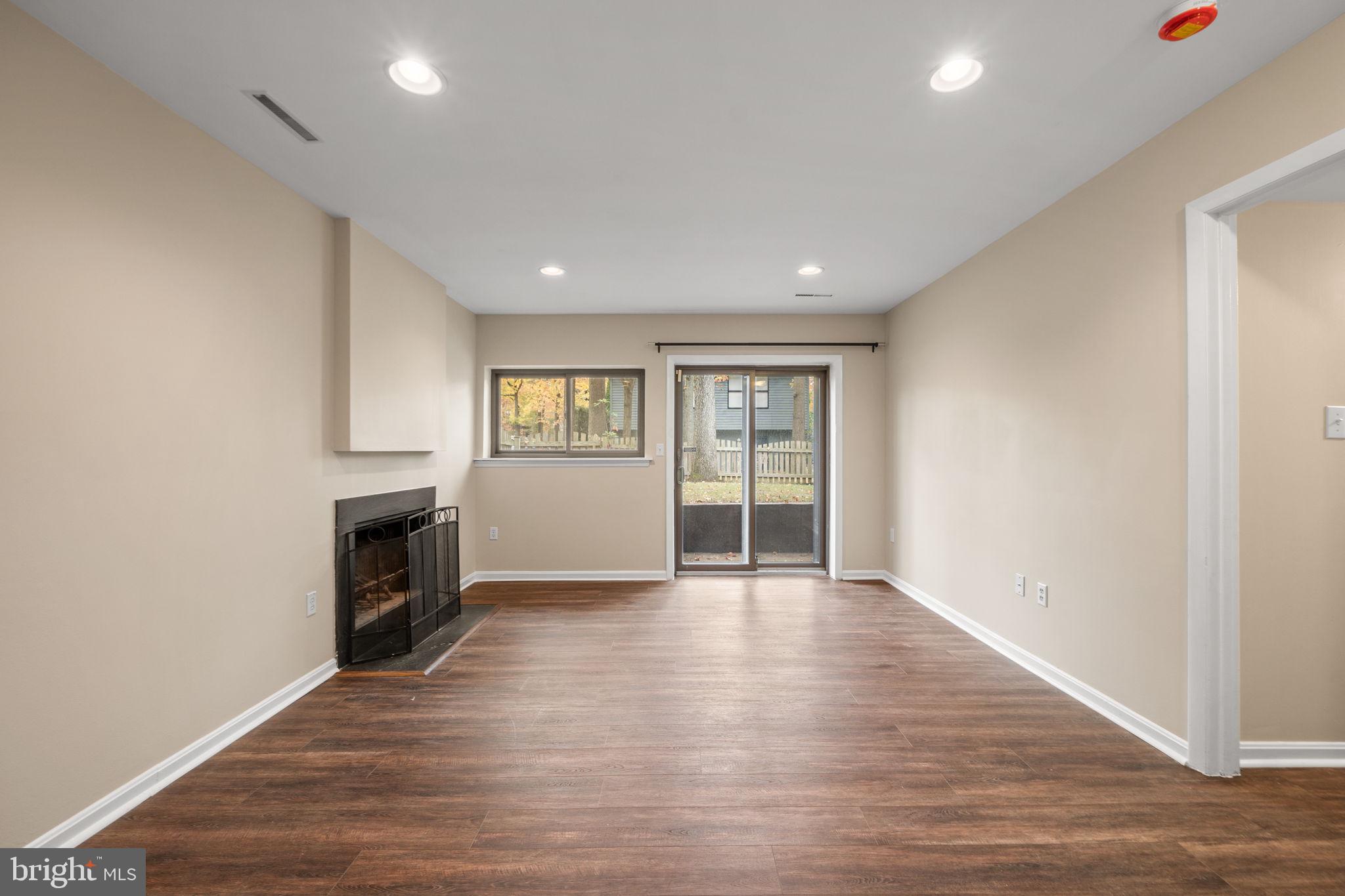 1813 Glade Court Annapolis, MD 21403 - Photo 27 of 35 a view of an empty room with window and wooden floor