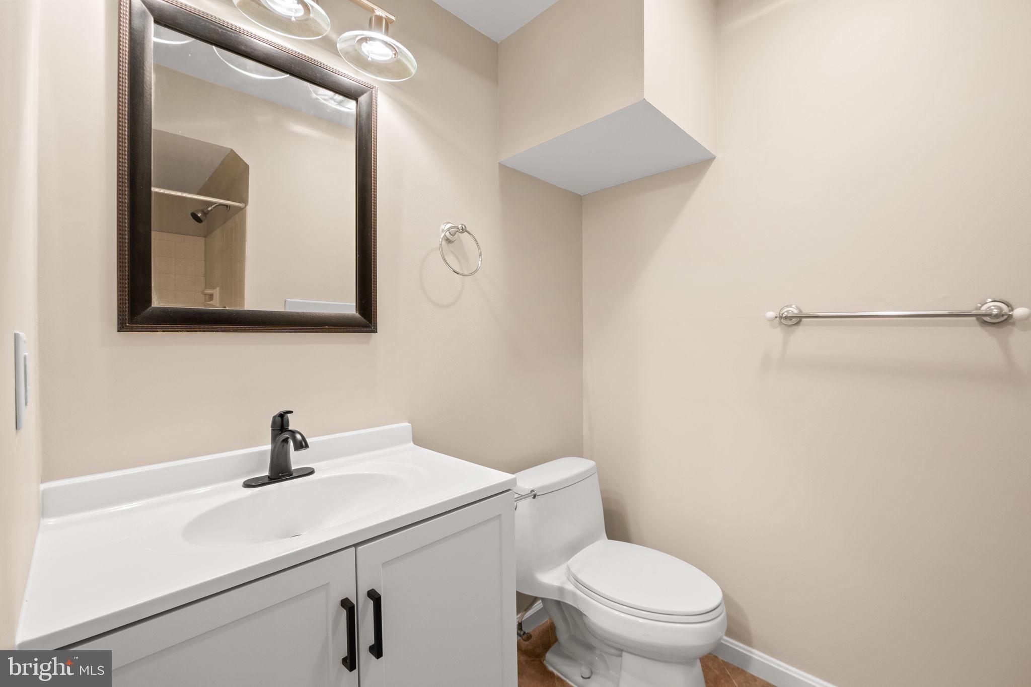 1813 Glade Court Annapolis, MD 21403 - Photo 31 of 35 a bathroom with a toilet a sink and mirror