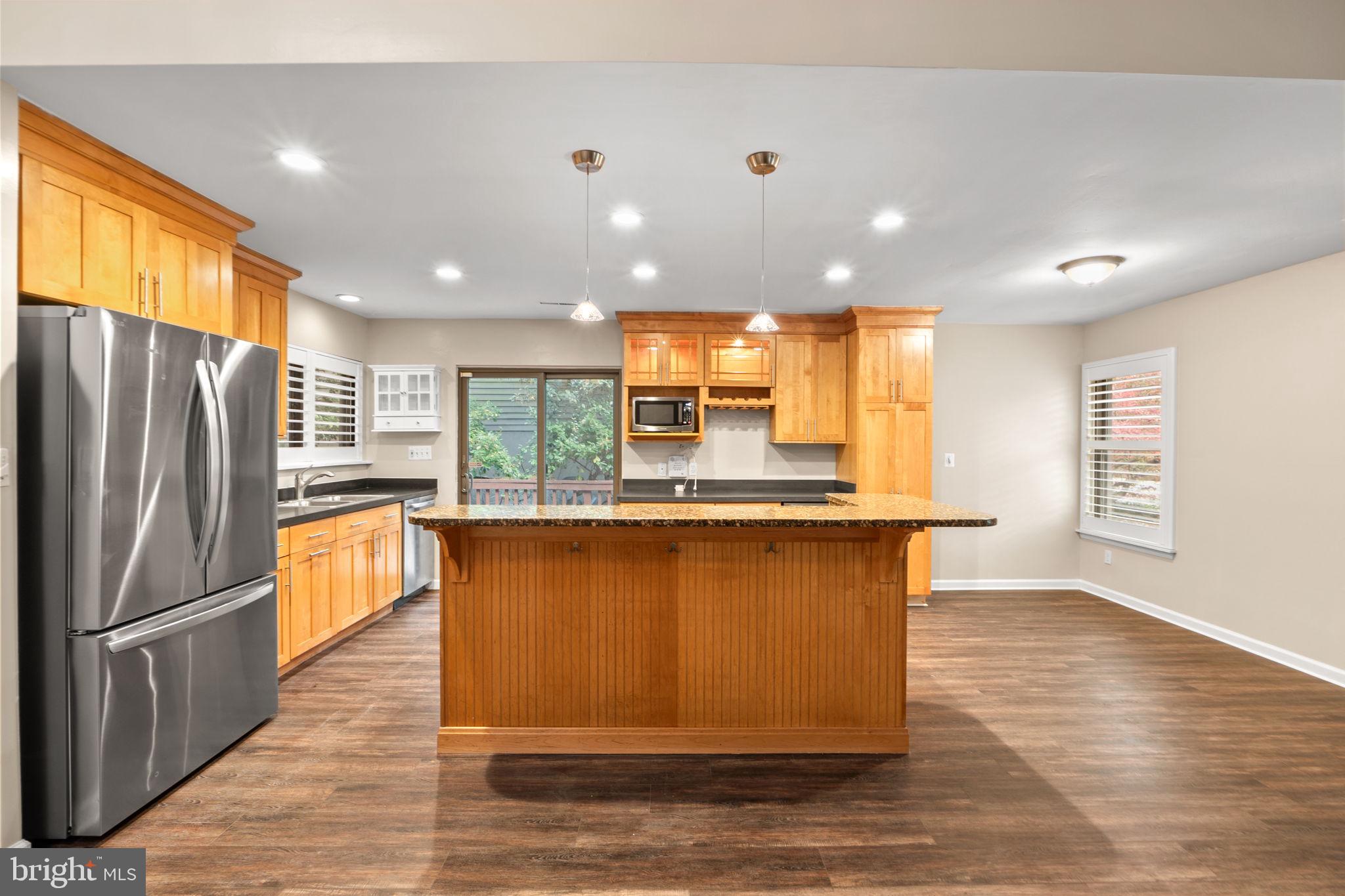 1813 Glade Court Annapolis, MD 21403 - Photo 6 of 35 a kitchen with stainless steel appliances granite countertop a refrigerator a sink a stove and a wooden floors