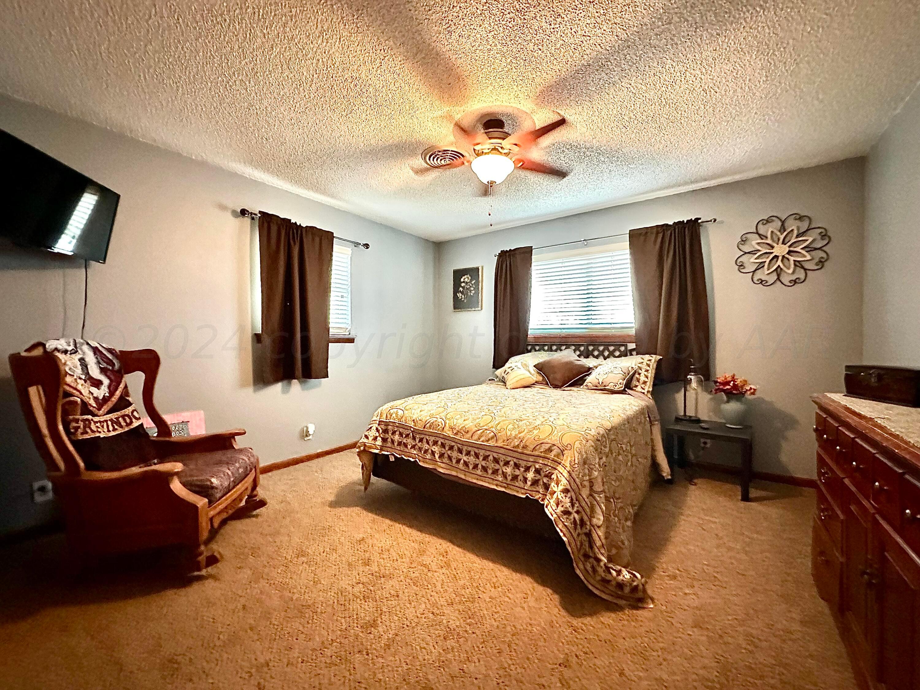 1404 Primrose Lane Borger, TX 79007 - Photo 13 of 27 a bedroom with a bed and furniture