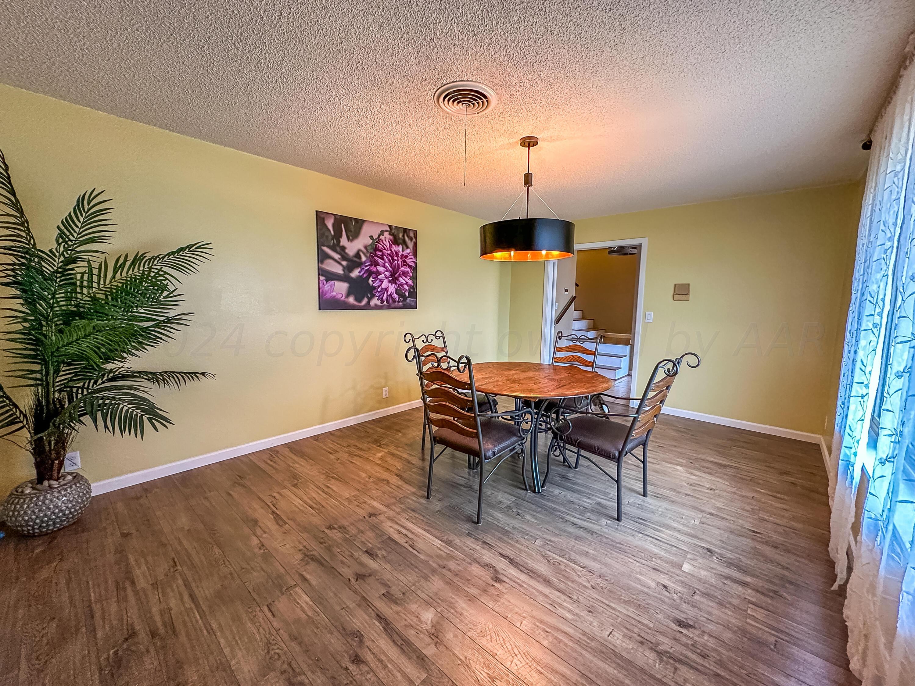 1404 Primrose Lane Borger, TX 79007 - Photo 5 of 27 a view of a dining room with furniture and wooden floor