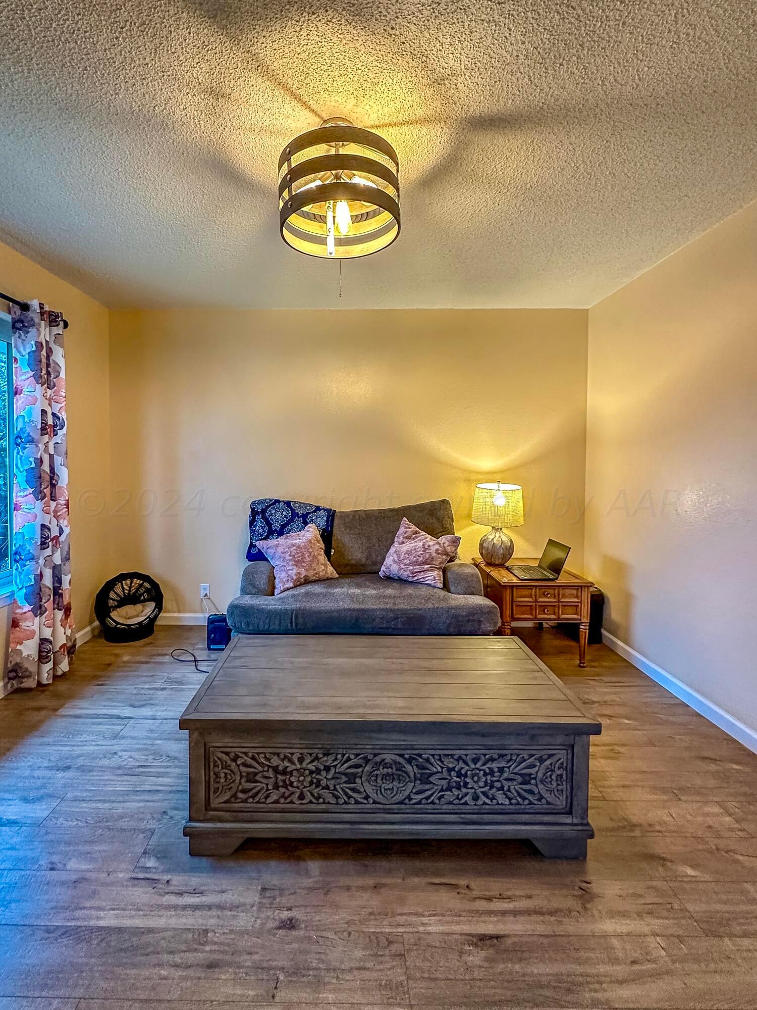1404 Primrose Lane Borger, TX 79007 - Photo 8 of 27 a view of a room with furniture and wooden floor