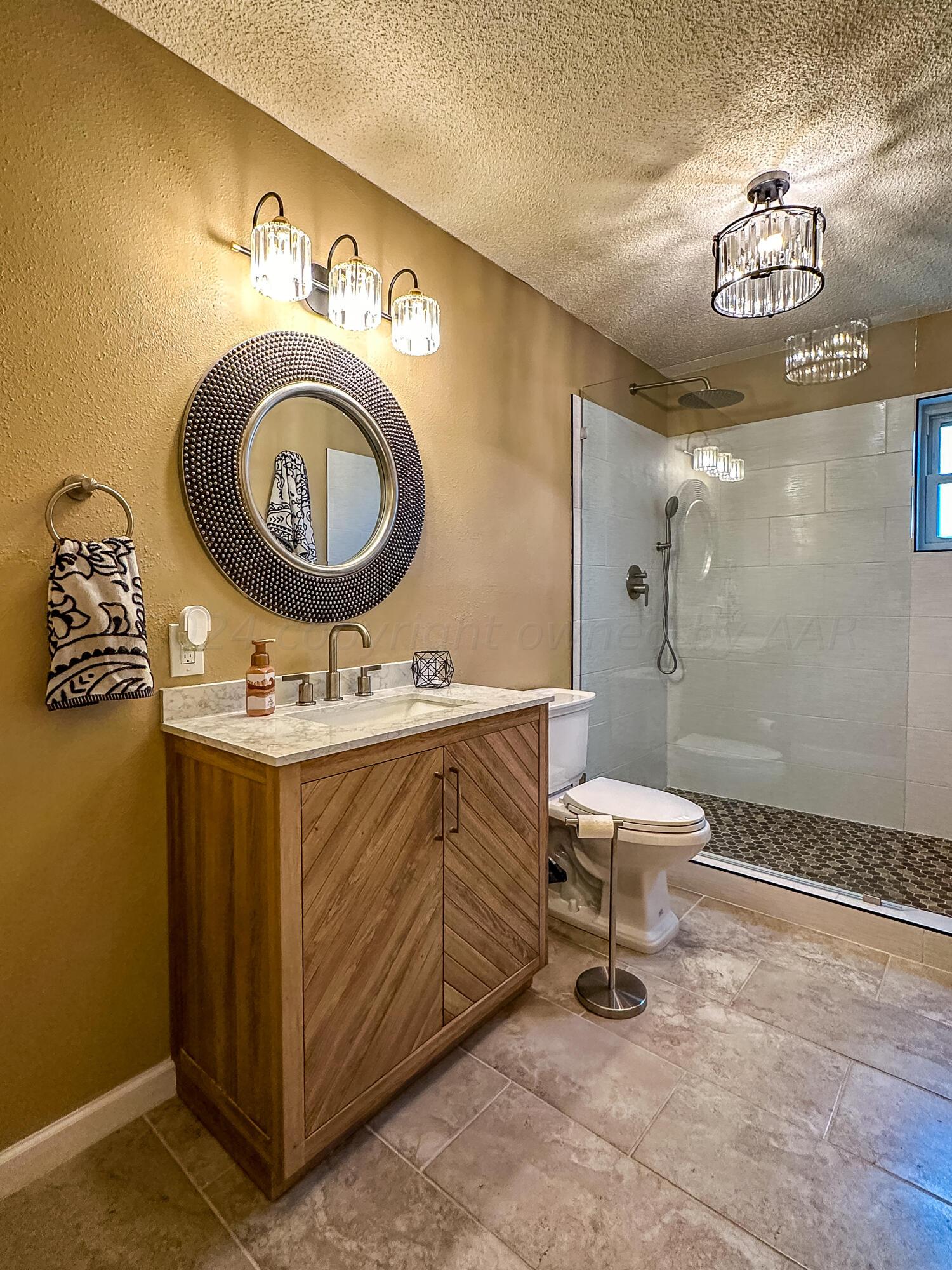 1404 Primrose Lane Borger, TX 79007 - Photo 10 of 27 a bathroom with a toilet a sink and mirror