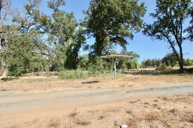a view of empty room with trees in the background