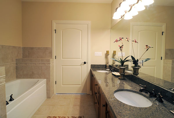 229 South Main Street, Unit 2E Lombard, IL 60148 - Photo 12 of 17 a bathroom with a granite countertop sink a mirror and a bathtub