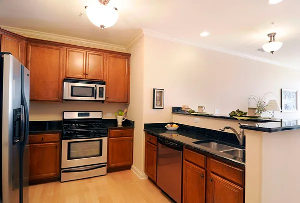 a kitchen that has a sink and a stove top oven