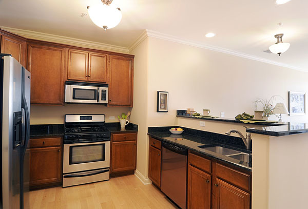 229 South Main Street, Unit 2E Lombard, IL 60148 - Photo 6 of 17 a kitchen that has a sink and a stove top oven