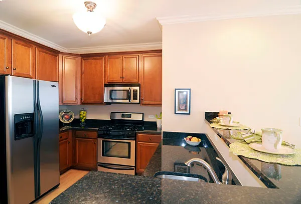 a kitchen with stainless steel appliances a sink and a refrigerator