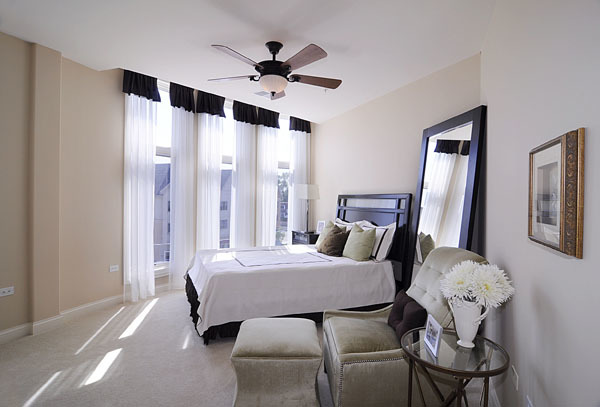 229 South Main Street, Unit 2E Lombard, IL 60148 - Photo 10 of 17 a bedroom with a bed and a chandelier