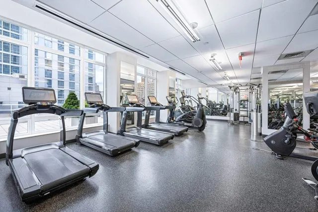 a room with gym equipment and a large window