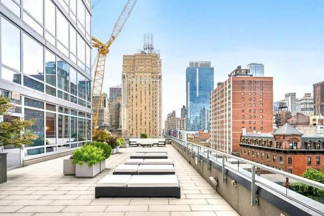 a living room with furniture a rug and a book shelf