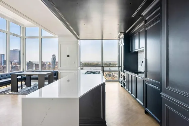 a kitchen with stainless steel appliances a sink stove and cabinets