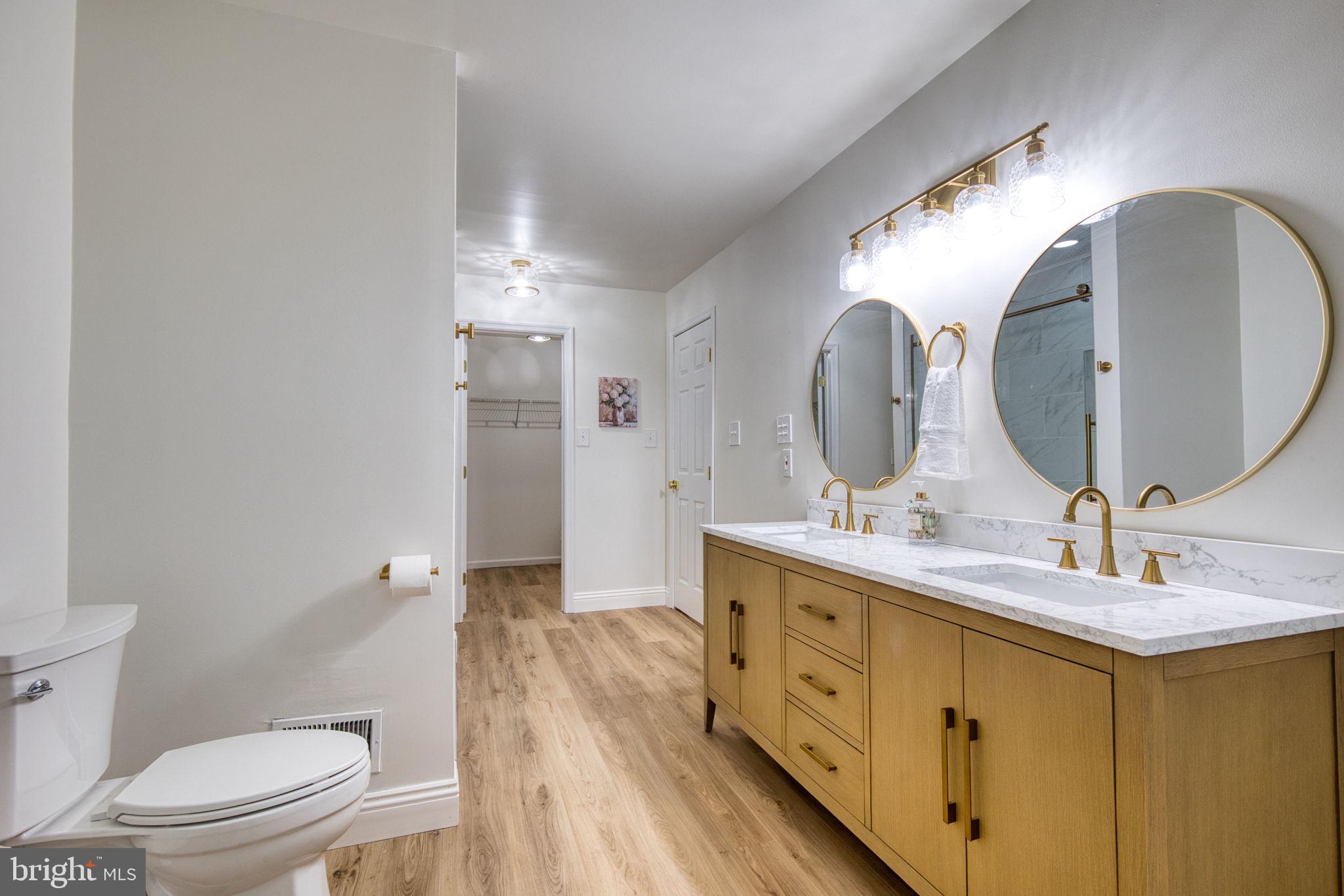 107 Walker Road Royersford, PA 19468 - Photo 24 of 41 a spacious bathroom with a double vanity sink toilet and a mirror