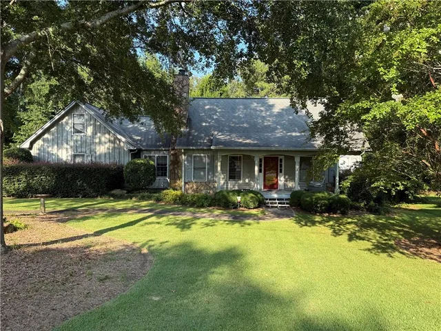 a view of a house with swimming pool and sitting area