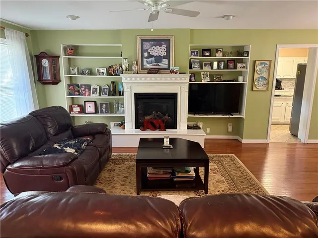 a living room with furniture kitchen view and a refrigerator