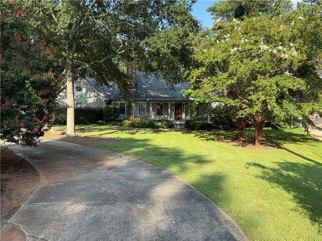 a view of swimming pool in front of house