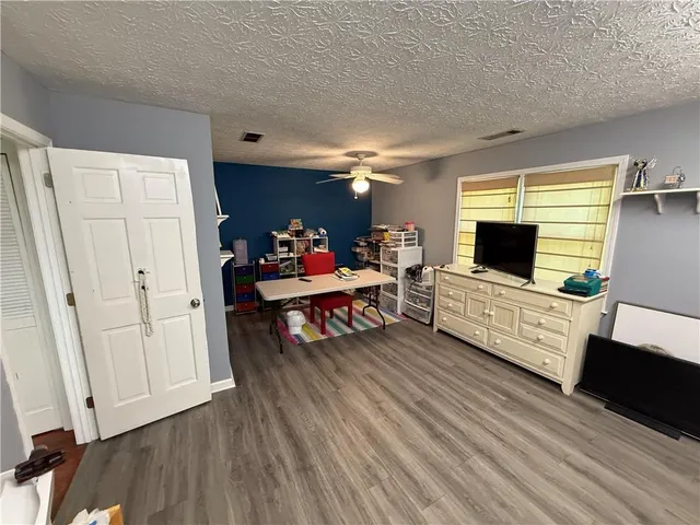 a bathroom with a granite countertop toilet sink and mirror