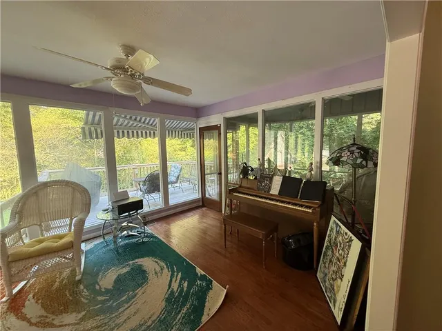 a balcony with wooden floor and outdoor seating
