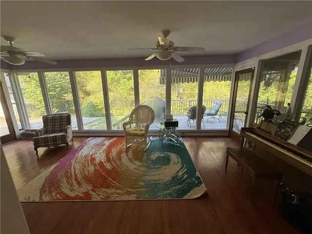 a balcony with wooden floor and outdoor seating
