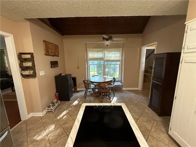 a kitchen with stainless steel appliances a stove a microwave a sink a refrigerator and cabinets