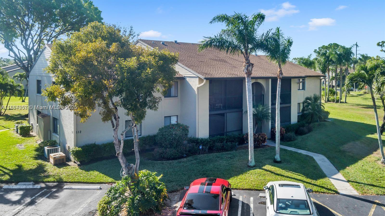 512 Shady Pine Way, Unit D2 Greenacres, FL 33415 - Photo 1 of 16 a view of backyard with swimming pool and outdoor seating