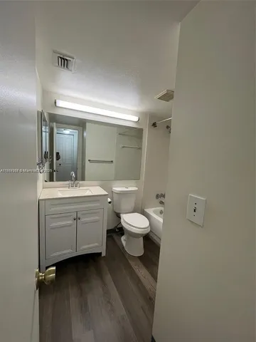 a bathroom with a sink a toilet and a shower