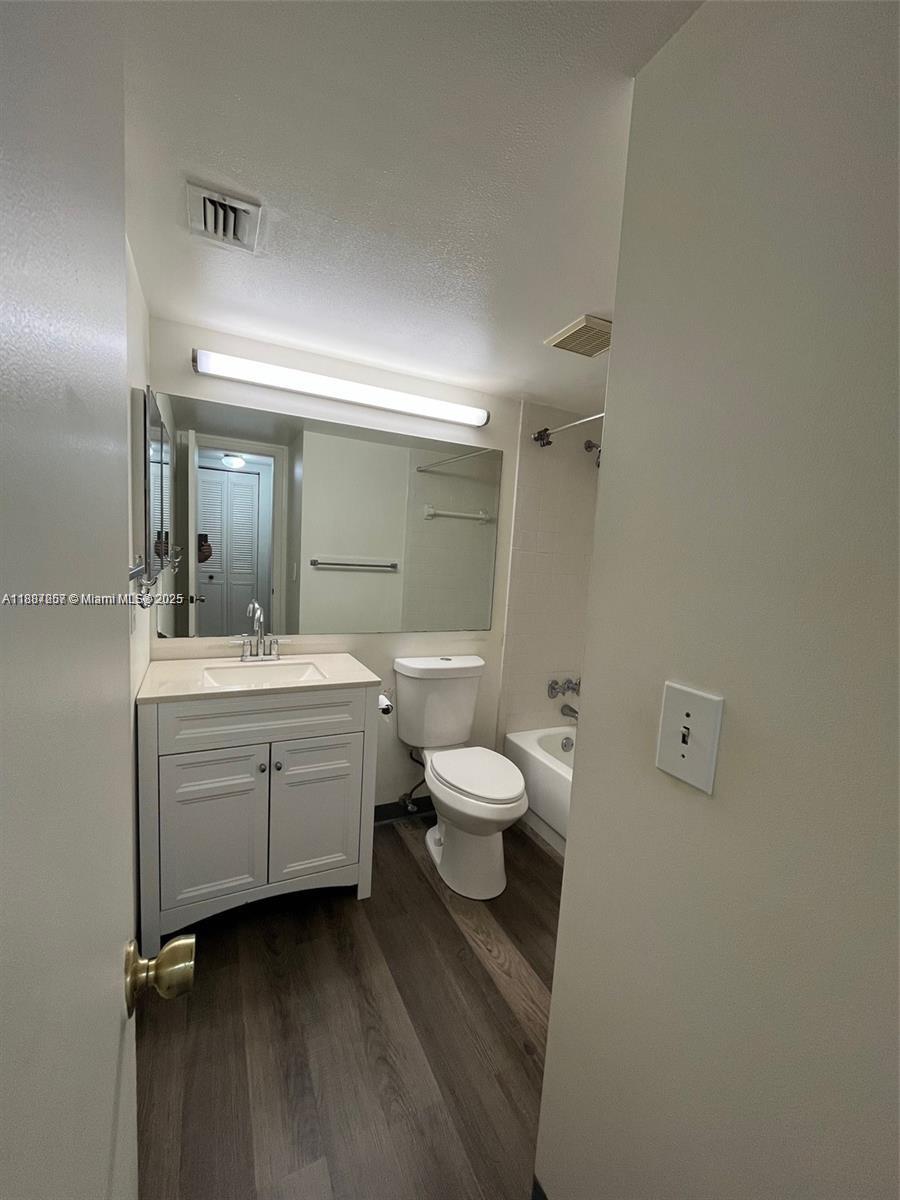 512 Shady Pine Way, Unit D2 Greenacres, FL 33415 - Photo 12 of 16 a bathroom with a double vanity sink a mirror and a toilet