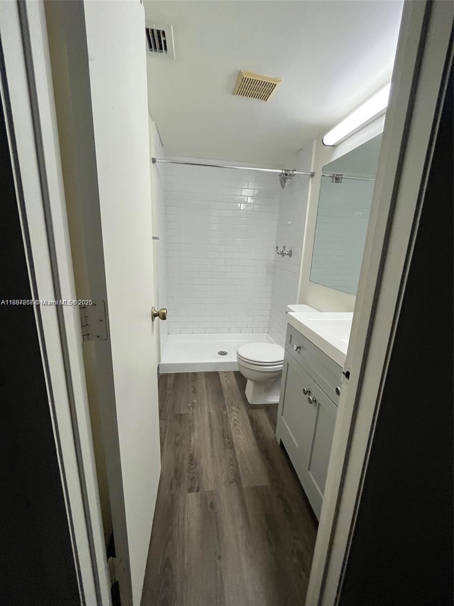 512 Shady Pine Way, Unit D2 Greenacres, FL 33415 - Photo 13 of 16 a bathroom with a sink a toilet and a shower