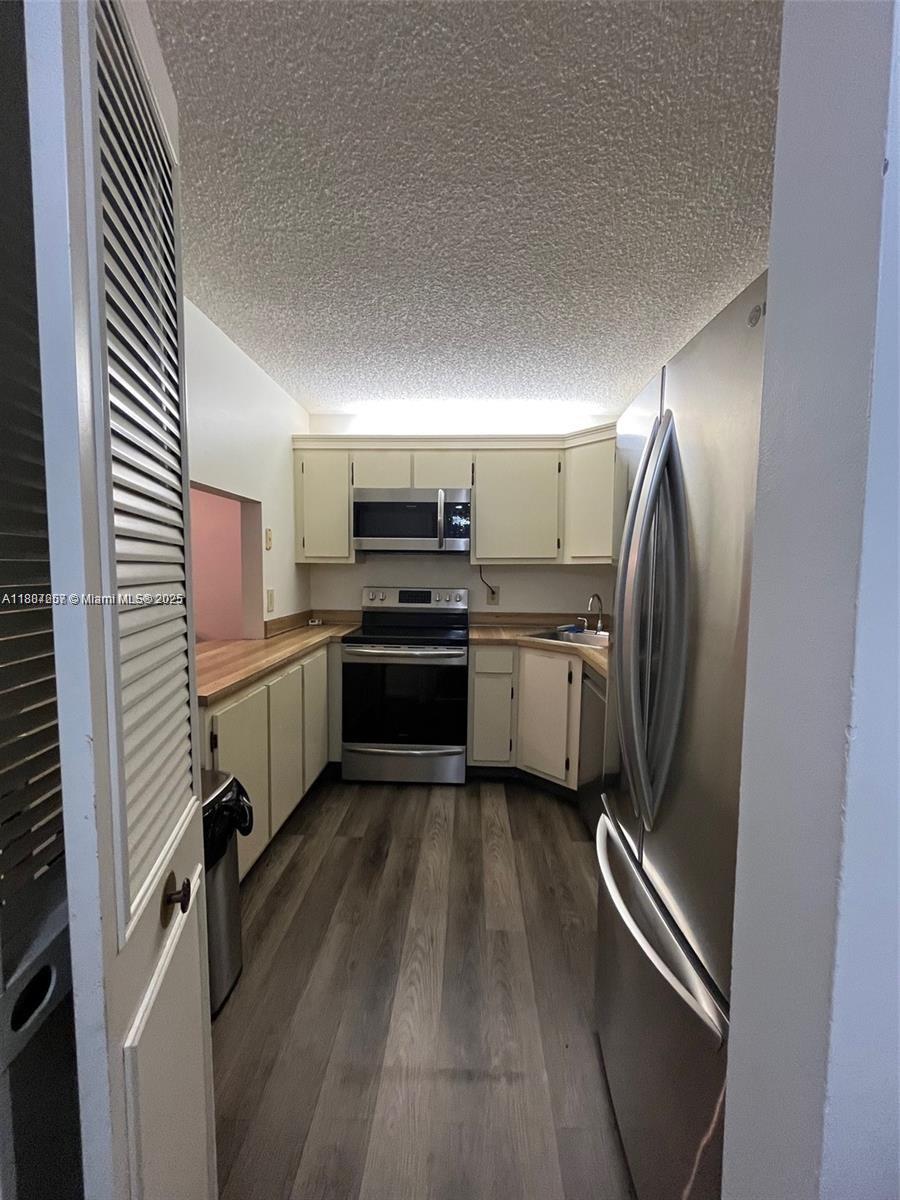 512 Shady Pine Way, Unit D2 Greenacres, FL 33415 - Photo 14 of 16 a kitchen with cabinets and stainless steel appliances