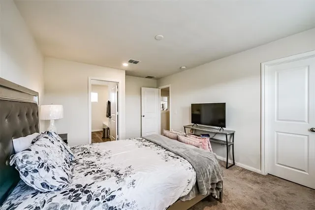 a bedroom with a bed and a flat screen tv