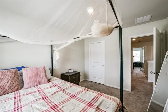 a bedroom with a bed and a mirror