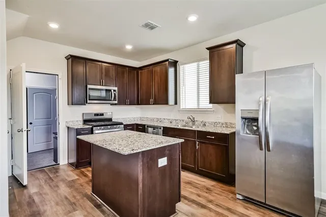 a kitchen with a sink stove and refrigerator