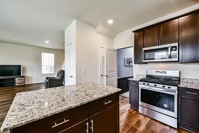 a kitchen with a stove microwave and refrigerator