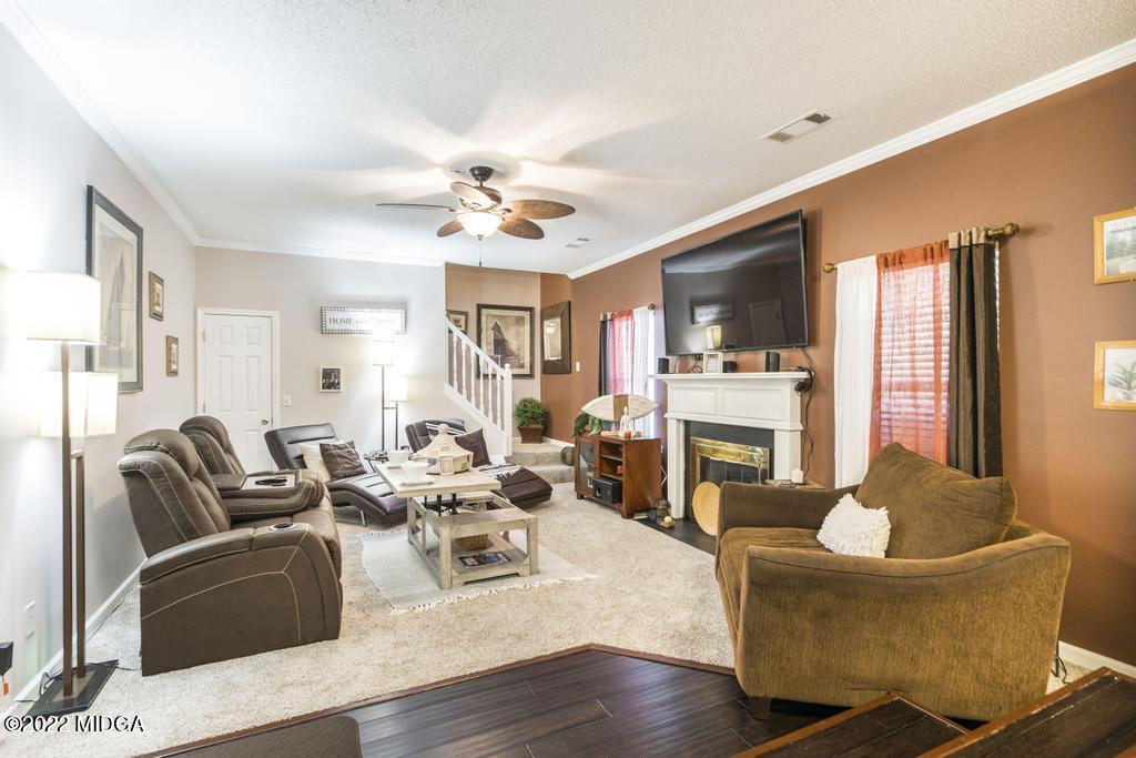 825 Kohl Drive McDonough, GA 30253 - Photo 17 of 59 a living room with fireplace furniture and a wooden floor