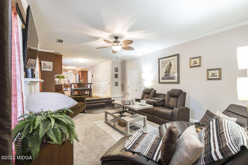 825 Kohl Drive McDonough, GA 30253 - Photo 19 of 59 a living room with furniture a chandelier and a window
