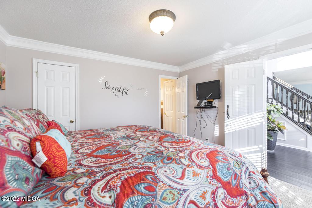 825 Kohl Drive McDonough, GA 30253 - Photo 21 of 59 a bedroom with a bed and a flat screen tv