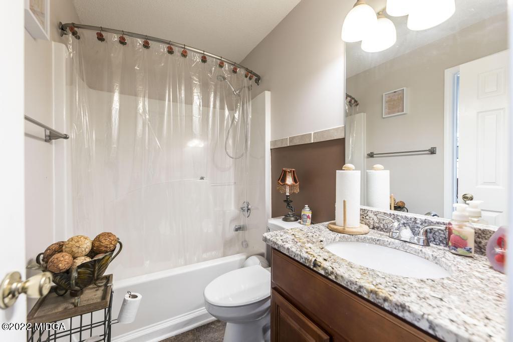 825 Kohl Drive McDonough, GA 30253 - Photo 22 of 59 a bathroom with a granite countertop sink mirror toilet and bathtub