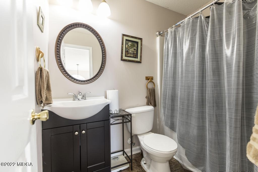 825 Kohl Drive McDonough, GA 30253 - Photo 30 of 59 a bathroom with a toilet a sink and a mirror