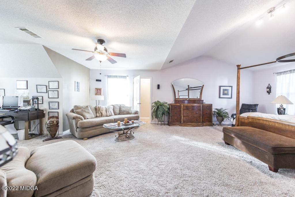 825 Kohl Drive McDonough, GA 30253 - Photo 33 of 59 a living room with furniture and a chandelier