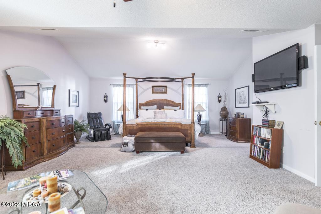 825 Kohl Drive McDonough, GA 30253 - Photo 34 of 59 a bedroom with a bed and flat screen tv