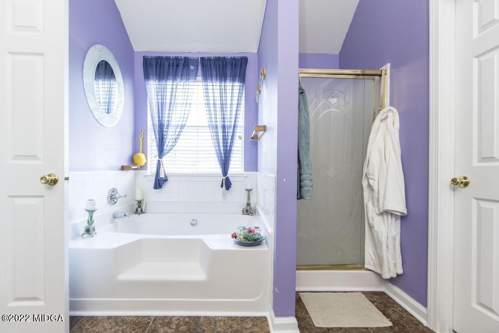 825 Kohl Drive McDonough, GA 30253 - Photo 40 of 59 a bathroom with a bathtub and a shower