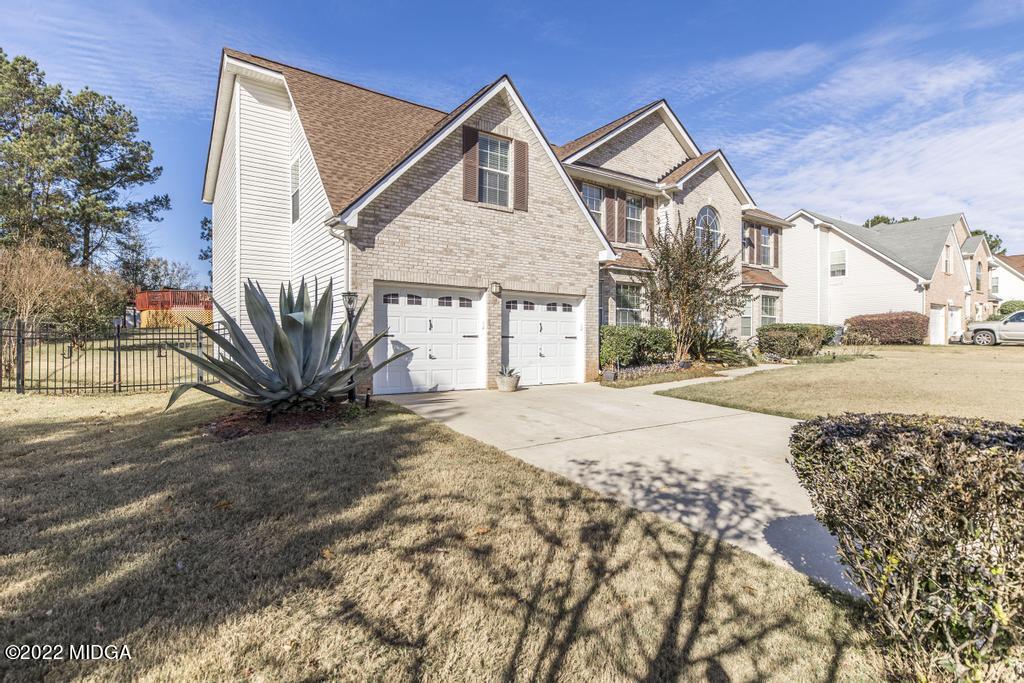 825 Kohl Drive McDonough, GA 30253 - Photo 4 of 59 a front view of a house with a yard and garage